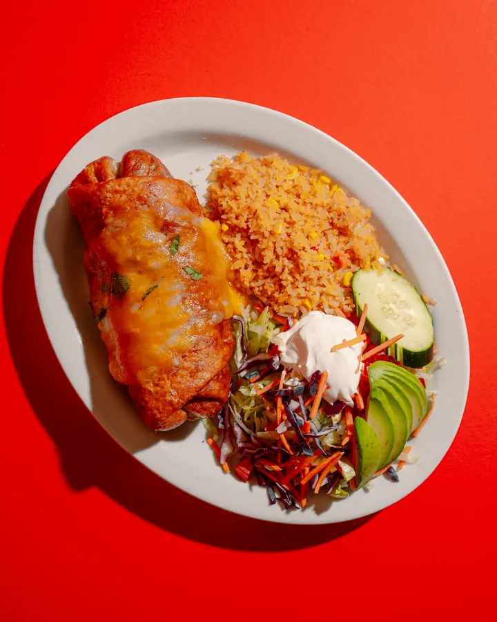 Chimichanga with rice, crema, avocado and shredded salad