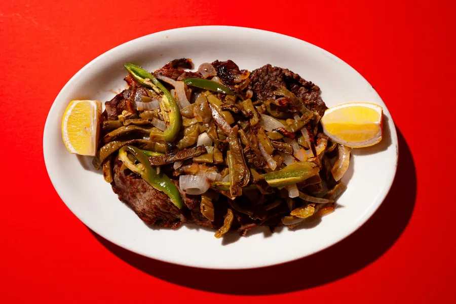 Carne asada plate with grilled cactus, onions and rice